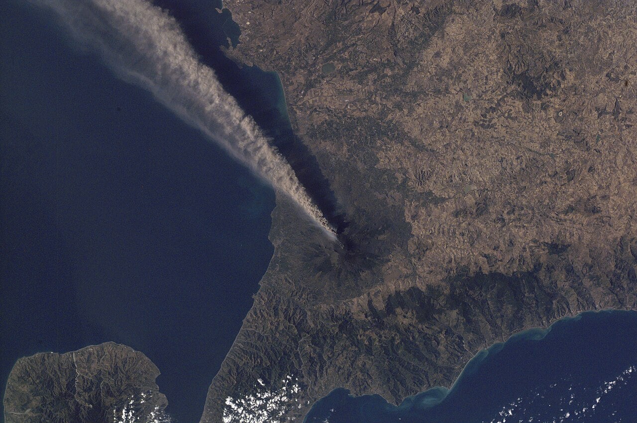 An ash plume streaming from Mount Etna across eastern Sicily, photographed from the International Space Station