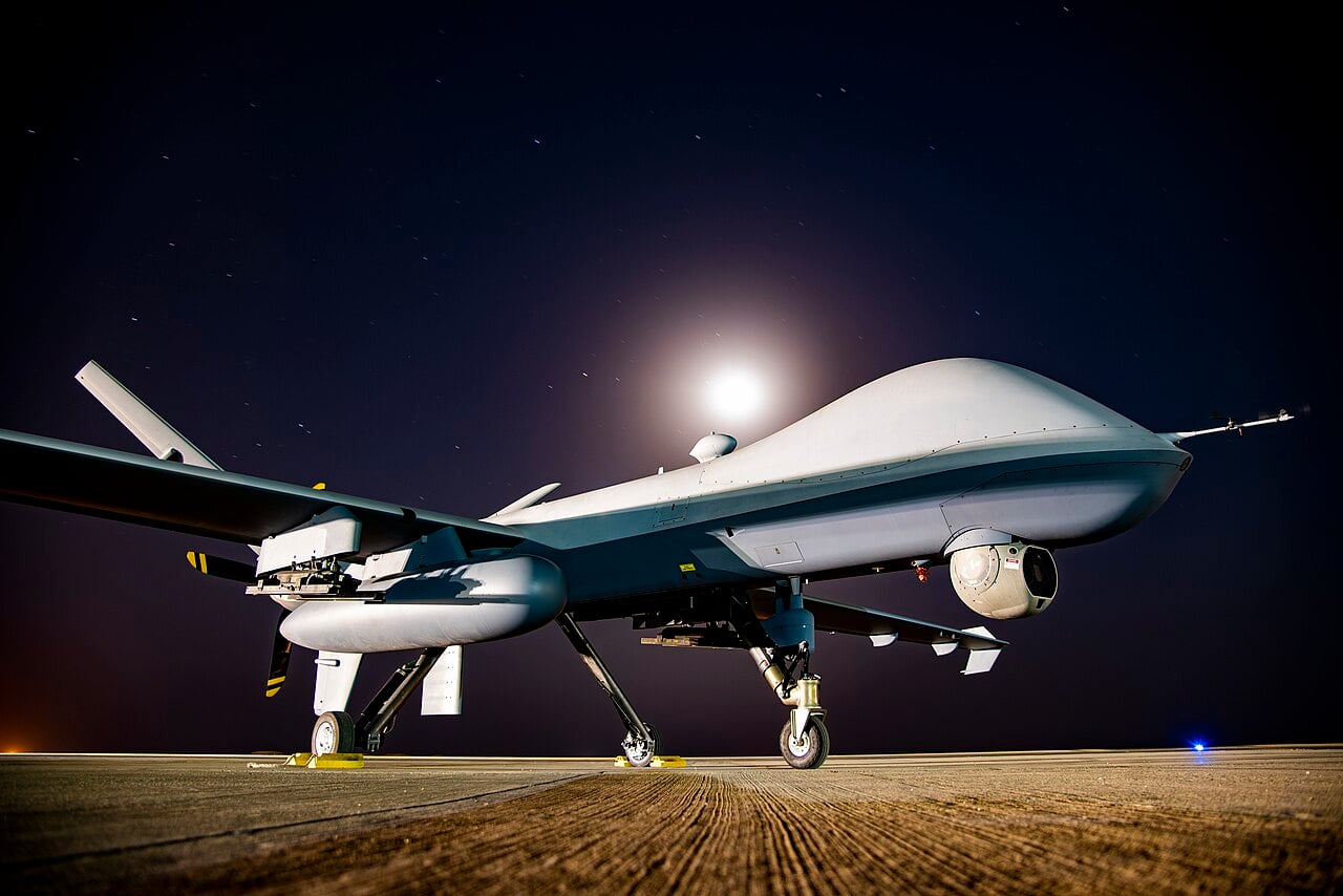 MQ-9 Reaper on a deployed flight line at night An armed MQ-9 Reaper on the flight line at a deployed location under a moonlit sky