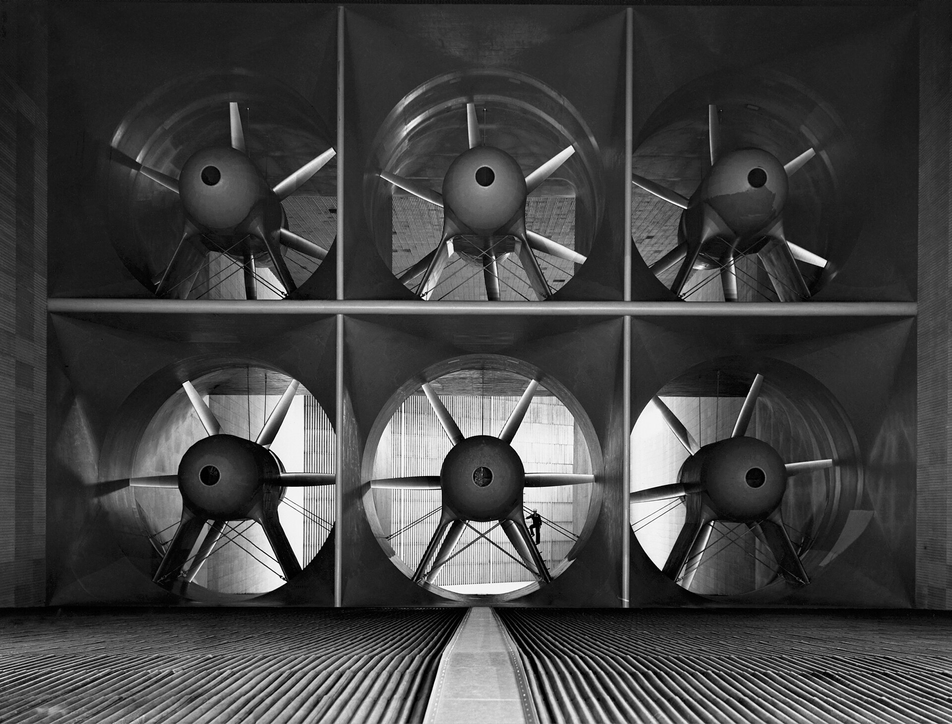 The six 40-foot-diameter fans of the Ames 40- by 80-foot wind tunnel in 1944, with a person standing between them for scale