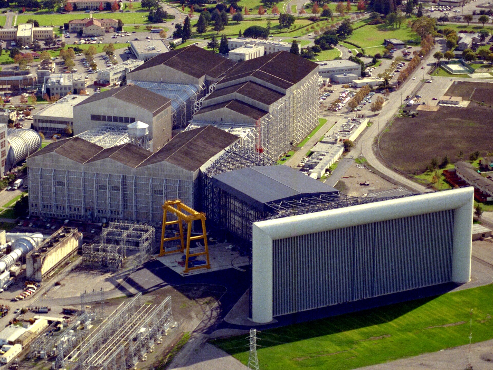 Aerial view of the NASA Ames wind tunnel complex with the giant white intake of the 80- by 120-foot tunnel under construction