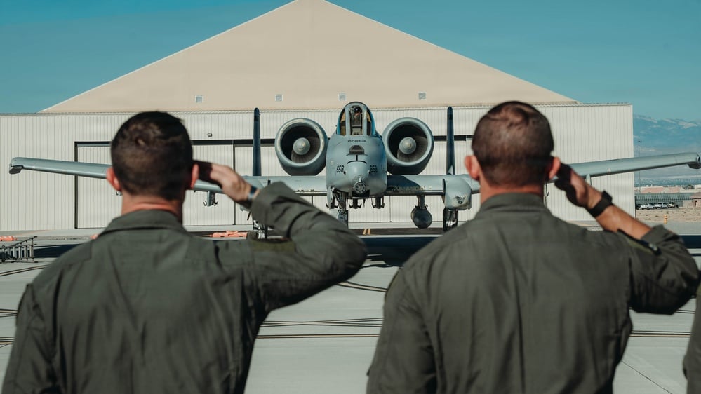 Two US Air Force officers salute an A-10 Thunderbolt II at Nellis Air Force Base