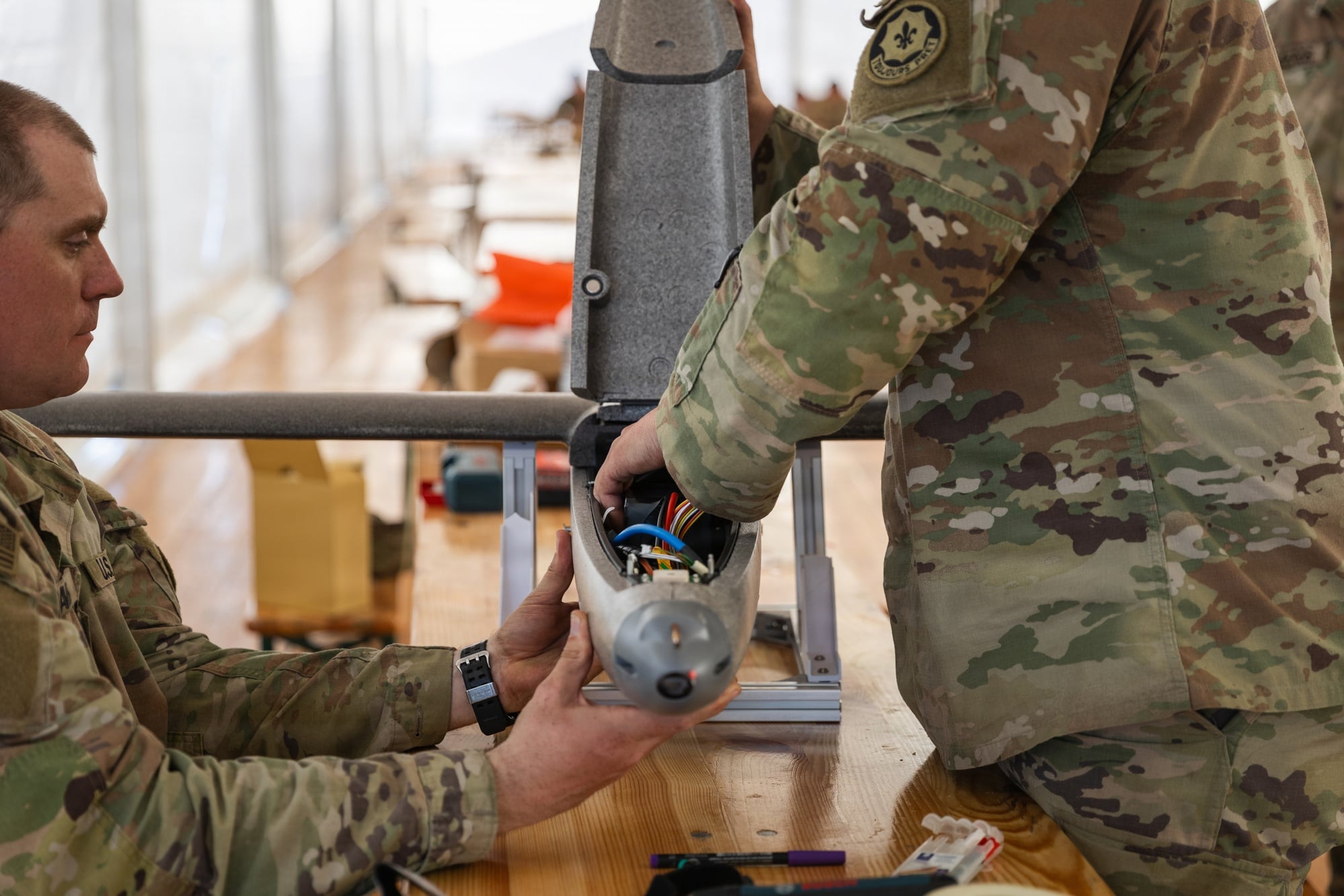 Soldiers assembling a one-way attack drone during a NATO exercise in Poland