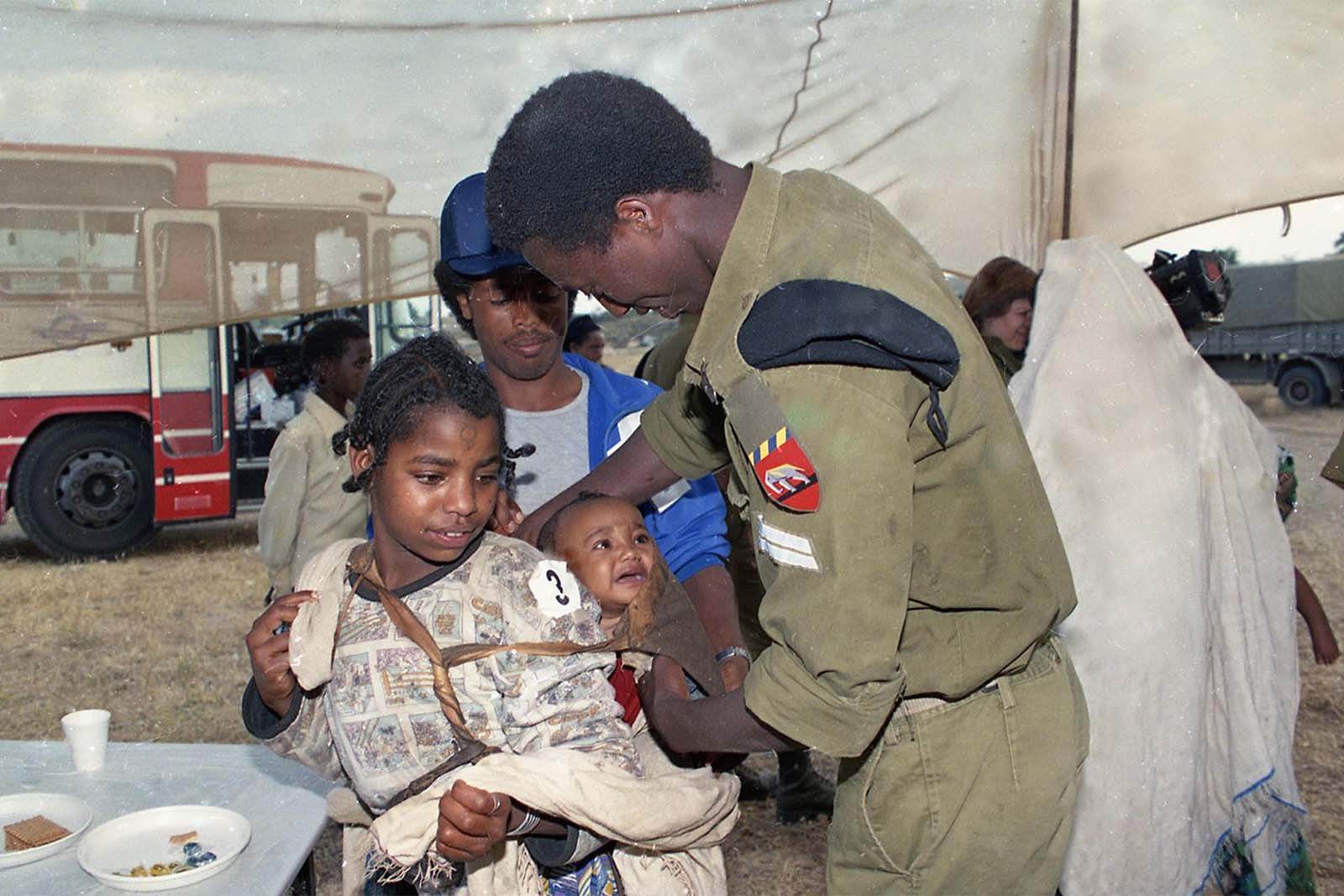 Israeli personnel receiving Ethiopian Jewish immigrants at the transit camp in Ethiopia, 1991
