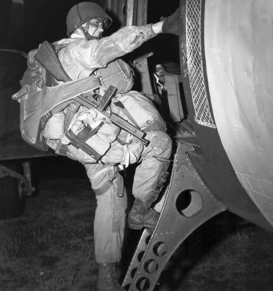 A paratrooper of the 101st Airborne Division climbing aboard a C-47 in 1944