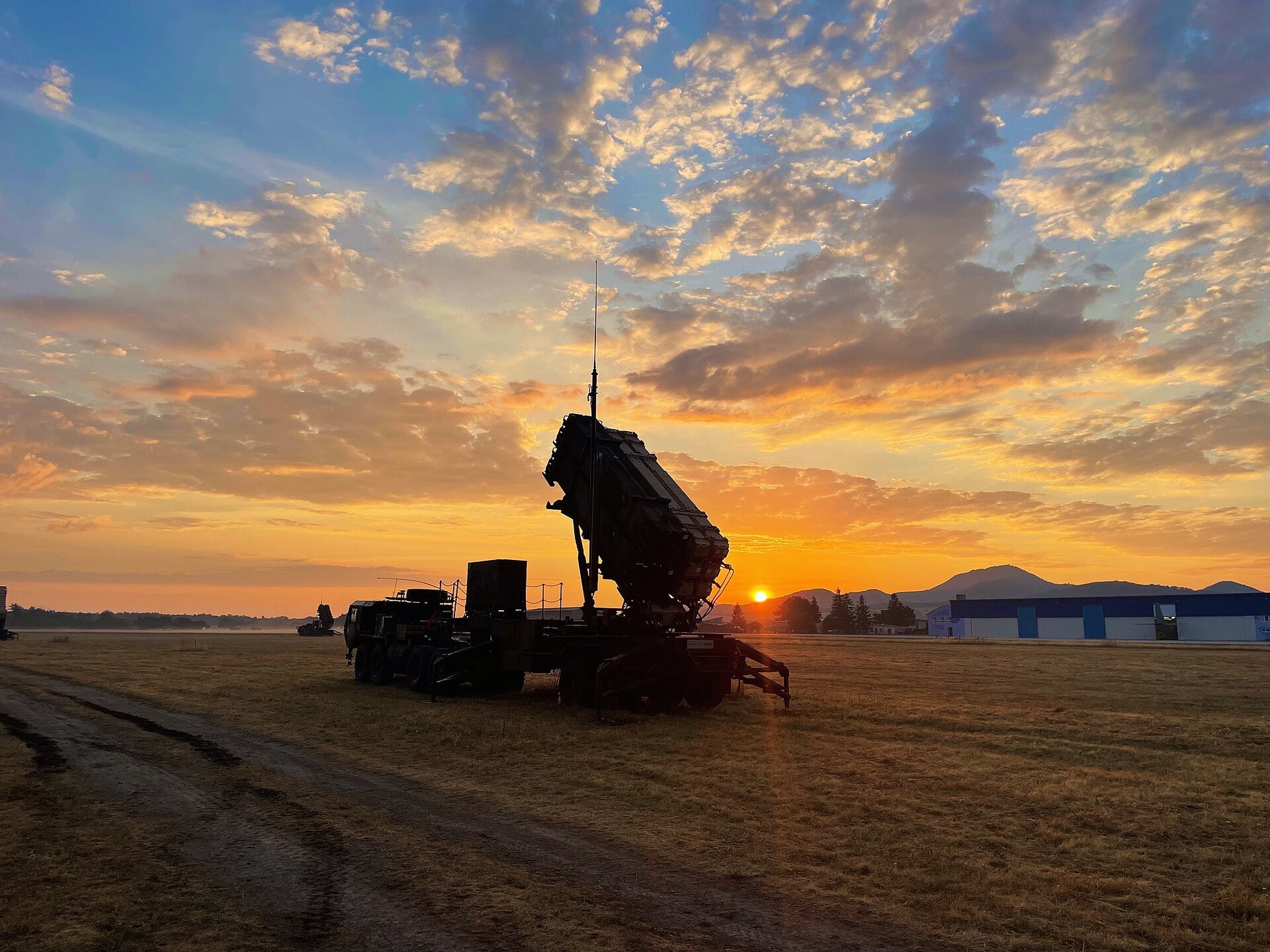 A Patriot missile launcher silhouetted at sunrise