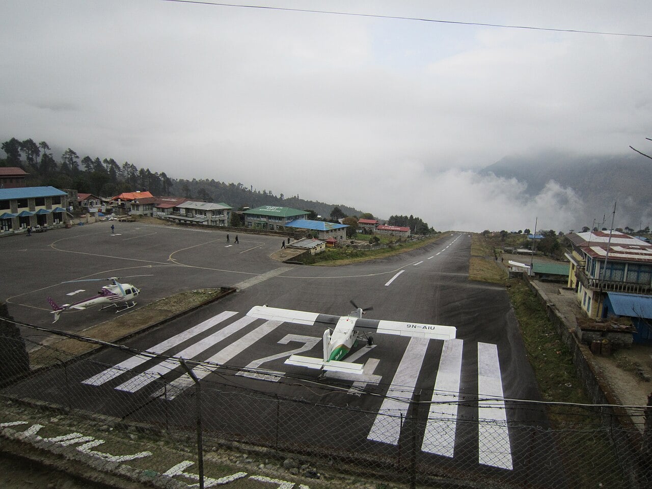 Tara Air Pilatus PC-6 Porter taking off downhill from Lukla in poor weather