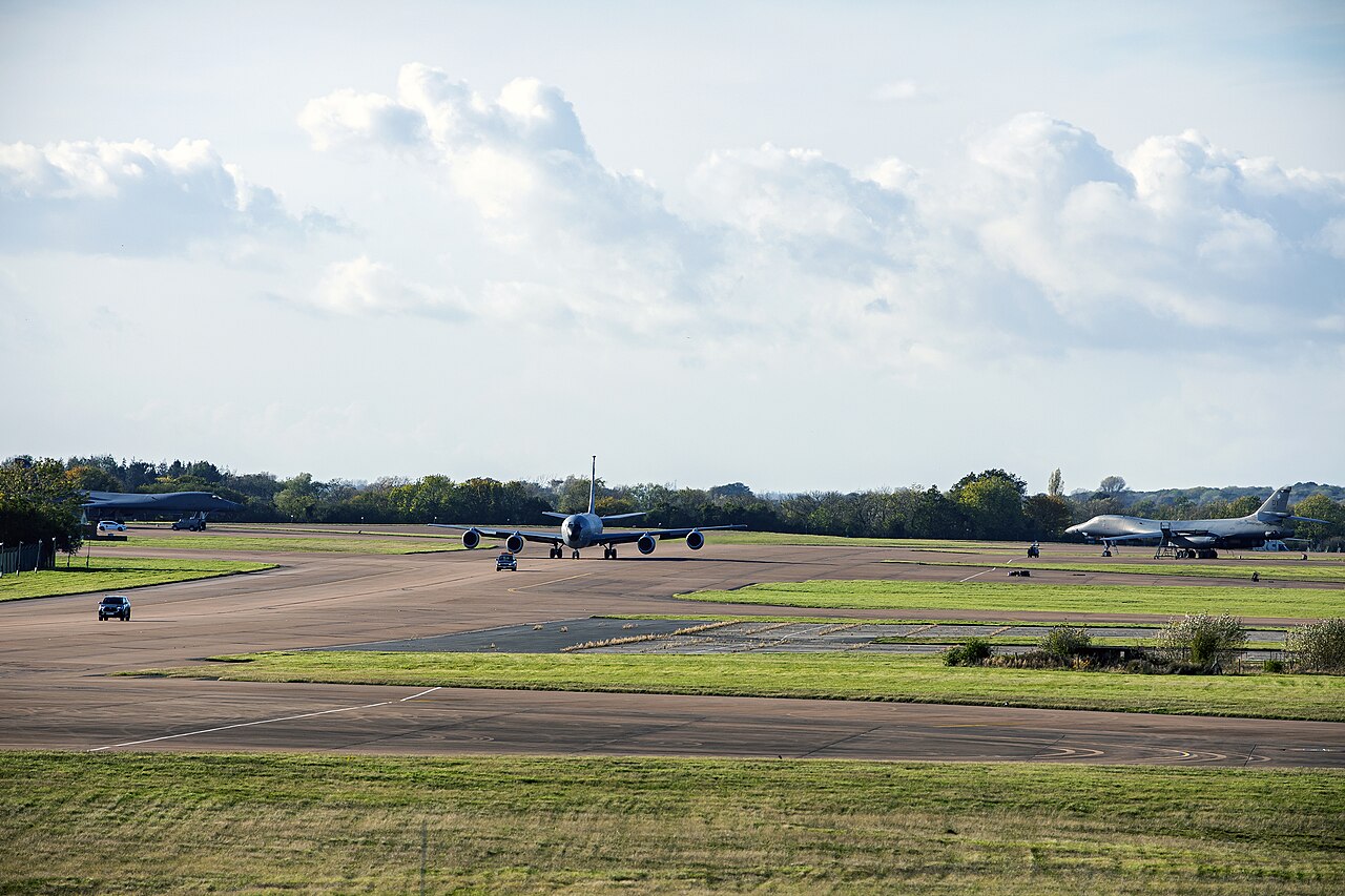 RAF Fairford runway during Agile Combat Employment operations KC-135 Stratotanker taxiing on the runway at RAF Fairford with bombers on the ramp