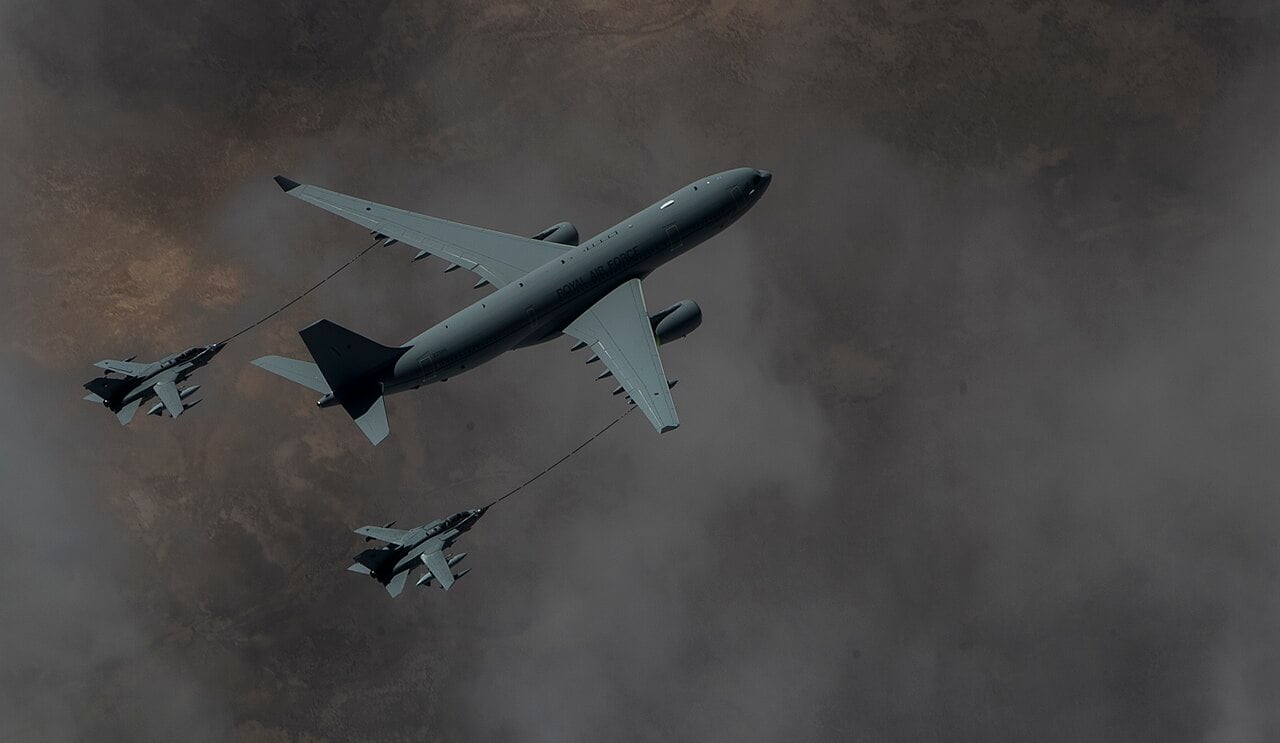 A Royal Air Force Voyager tanker trails two hoses to refuel a pair of RAF Tornado GR4s
