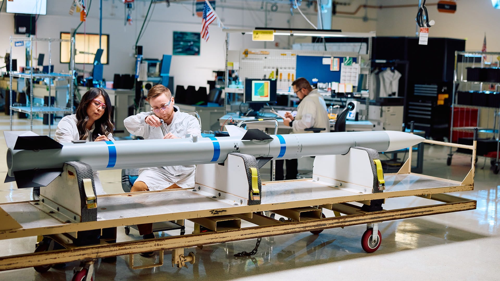 Raytheon technicians working on an AIM-120 AMRAAM missile on the production floor in Tucson, Arizona