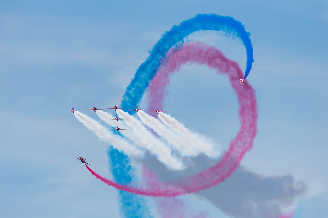 Red Arrows Hawk T1A formation with red, white and blue smoke at RIAT 2024 Red Arrows Hawk T1A formation with red, white and blue smoke at RIAT 2024