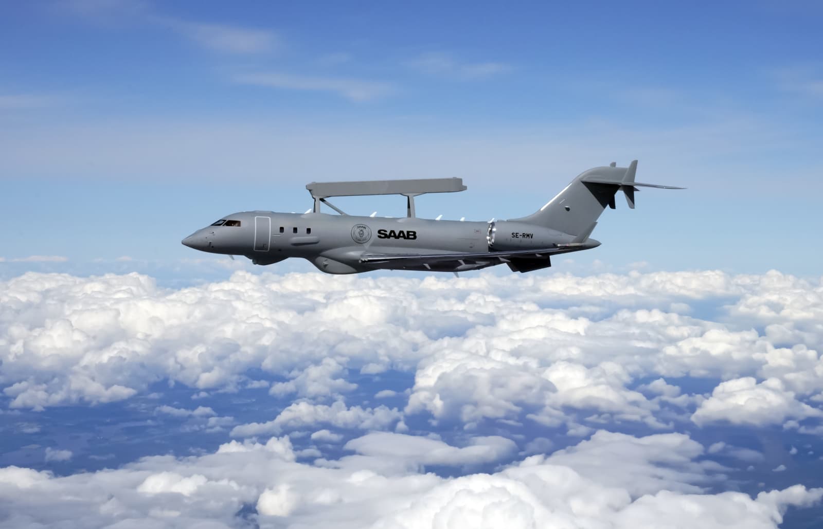 A Saab GlobalEye airborne early warning and control aircraft in flight above cloud