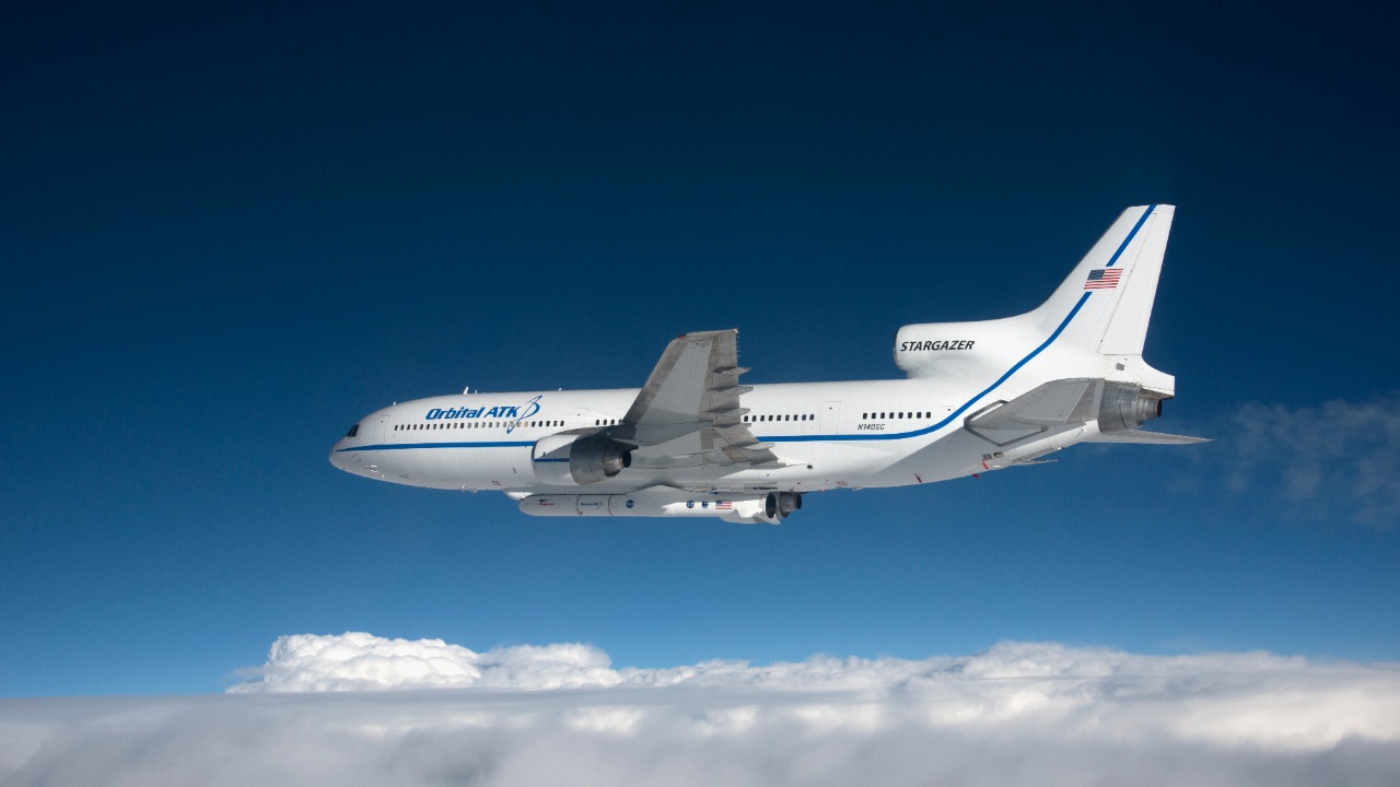 The L-1011 Stargazer carrying a Pegasus rocket under its fuselage over the Atlantic