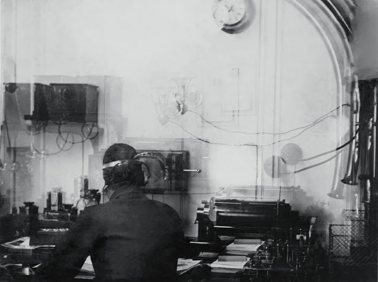 The Marconi wireless room aboard RMS Titanic with an operator seated at the desk