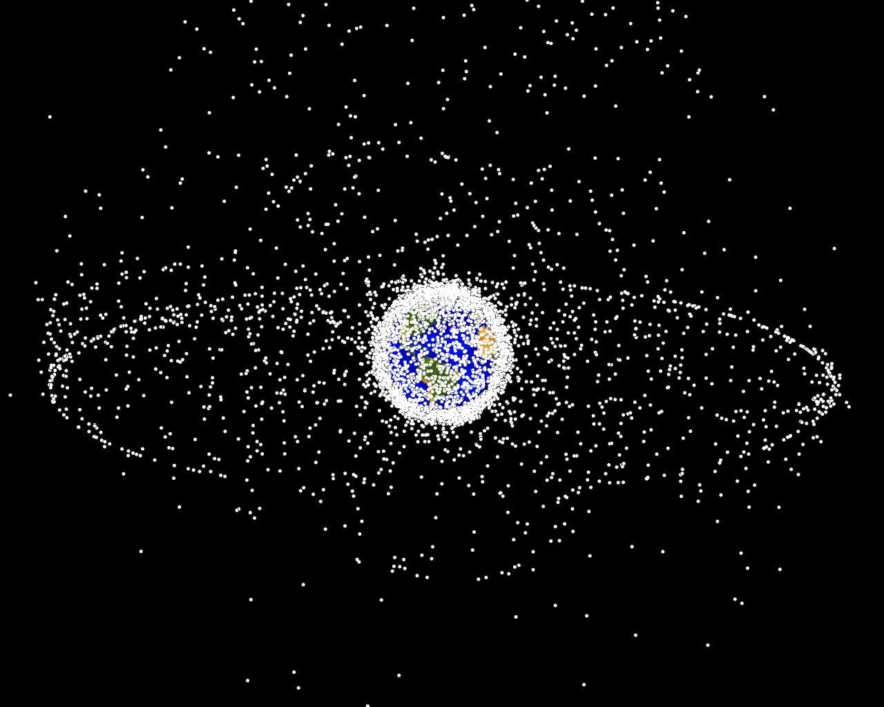 NASA plot of tracked objects in Earth orbit showing the dense low orbit cloud and the geosynchronous ring