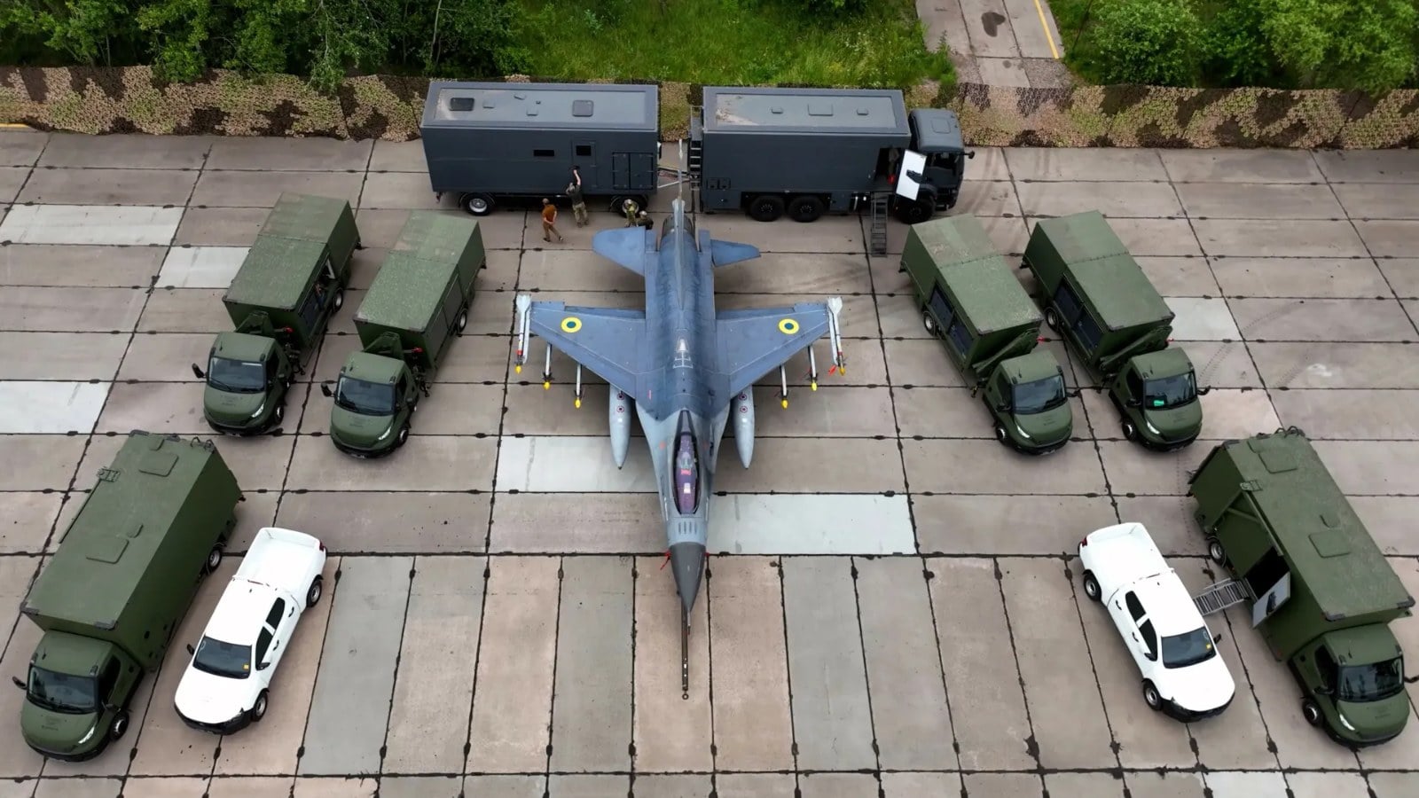 Ukrainian Air Force F-16 surrounded by its mobile support trucks