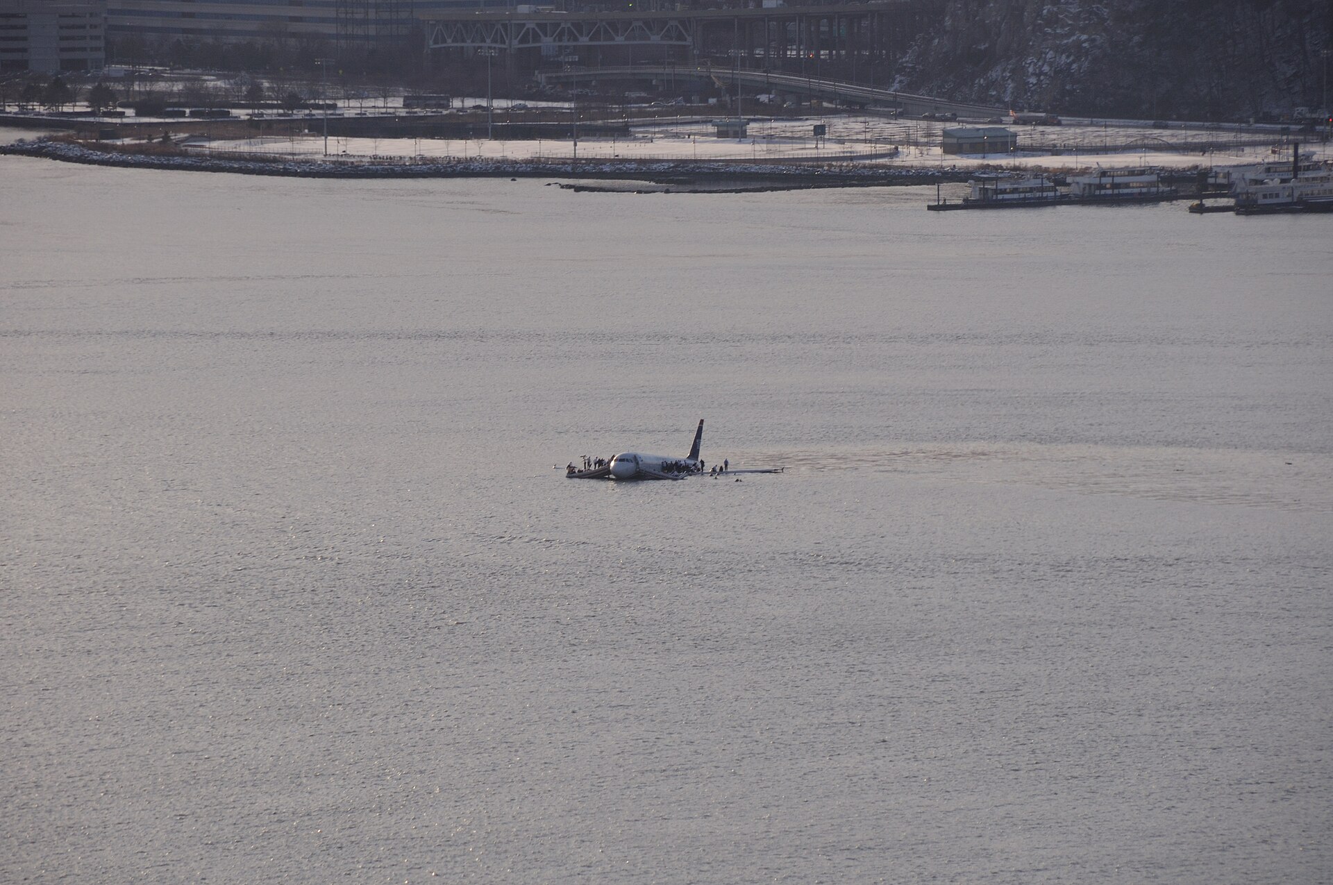 US Airways Flight 1549 floating in the Hudson River surrounded by ferries