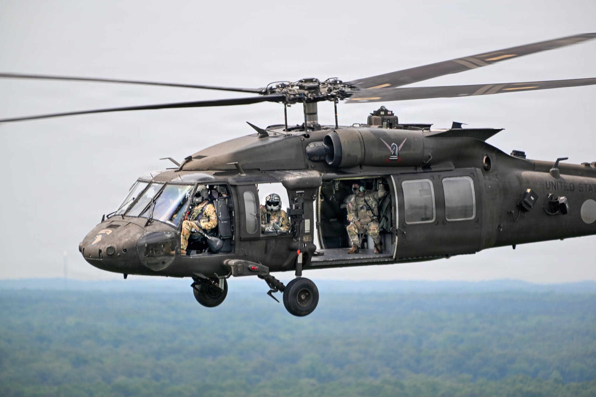 A US Army UH-60 Black Hawk helicopter in flight during airborne operations
