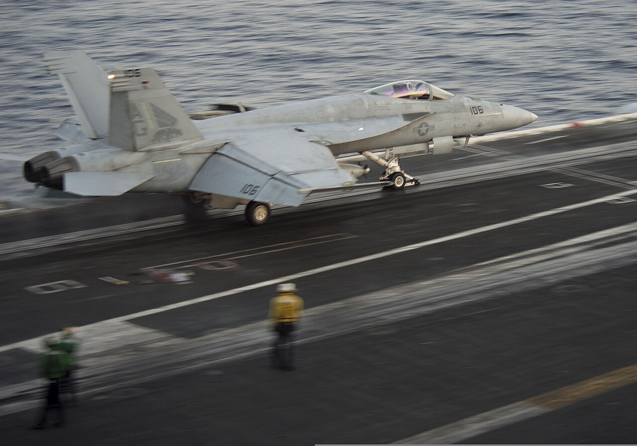 A US Navy F/A-18E Super Hornet launches from a carrier flight deck in the Arabian Sea