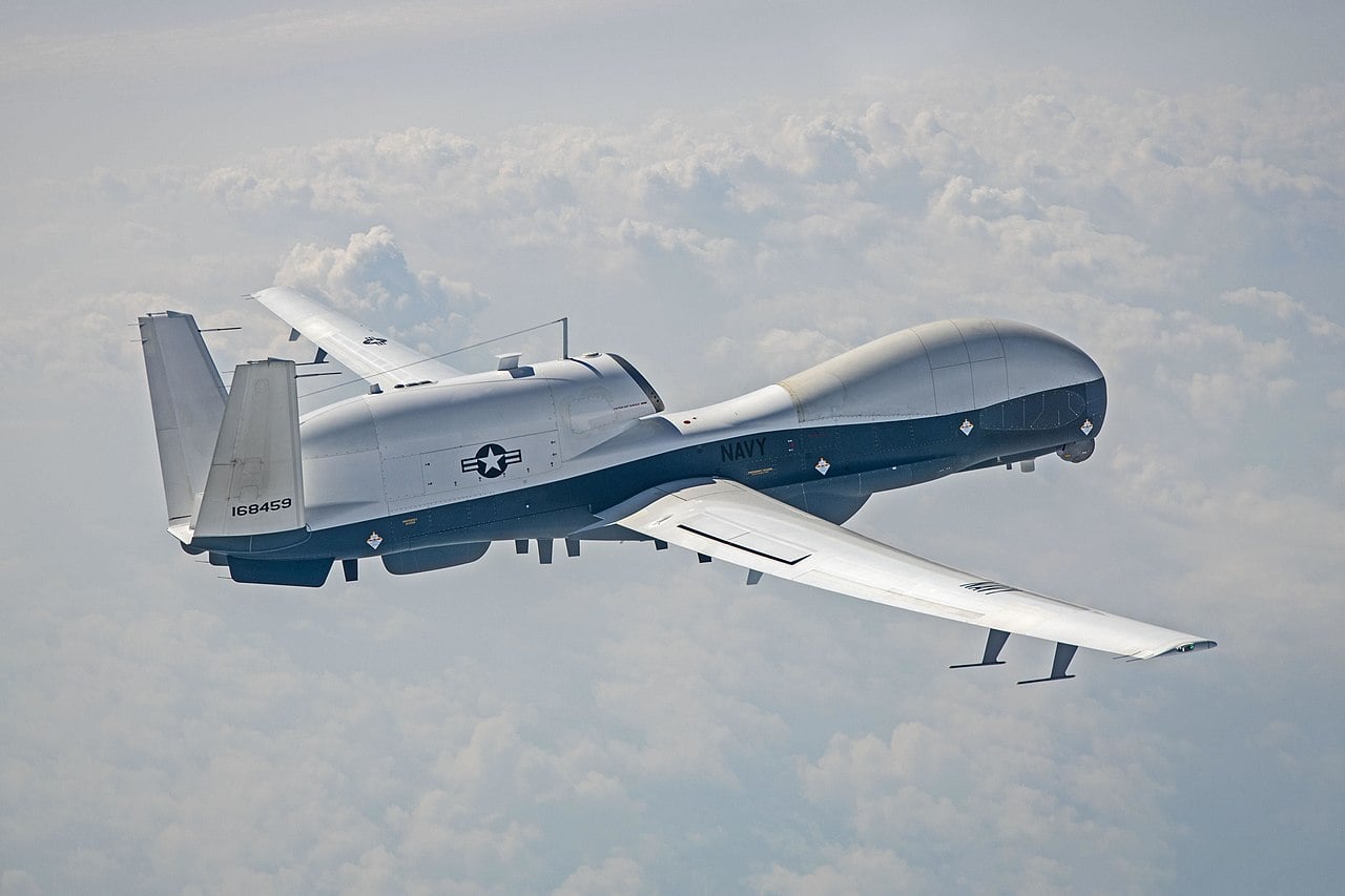 US Navy MQ-4C Triton in flight A US Navy MQ-4C Triton in flight above a cloud layer