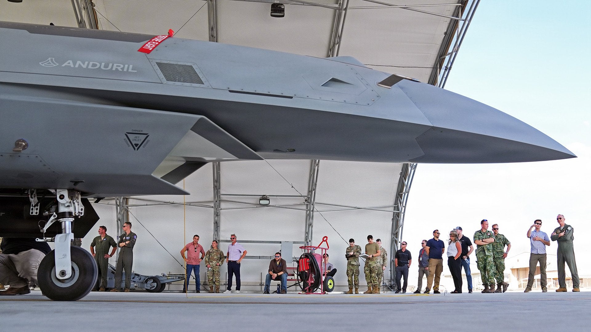 A Collaborative Combat Aircraft in a shelter with personnel alongside