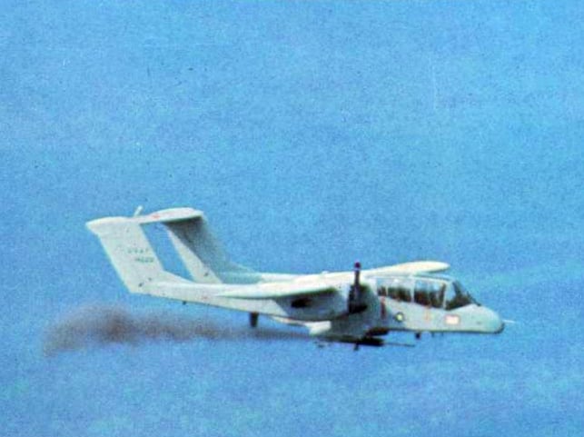 A US Air Force OV-10A Bronco forward air control aircraft firing a rocket over Vietnam, circa 1969