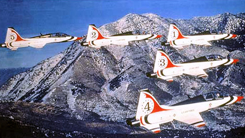 USAF Thunderbirds T-38 Talons numbered one to five flying over mountains
