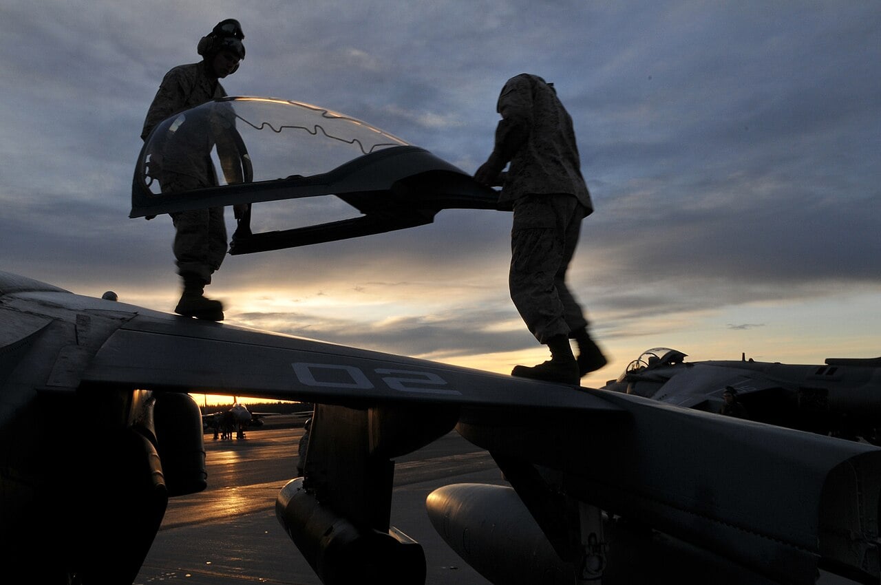 Marines handling the canopy of an AV-8B Harrier