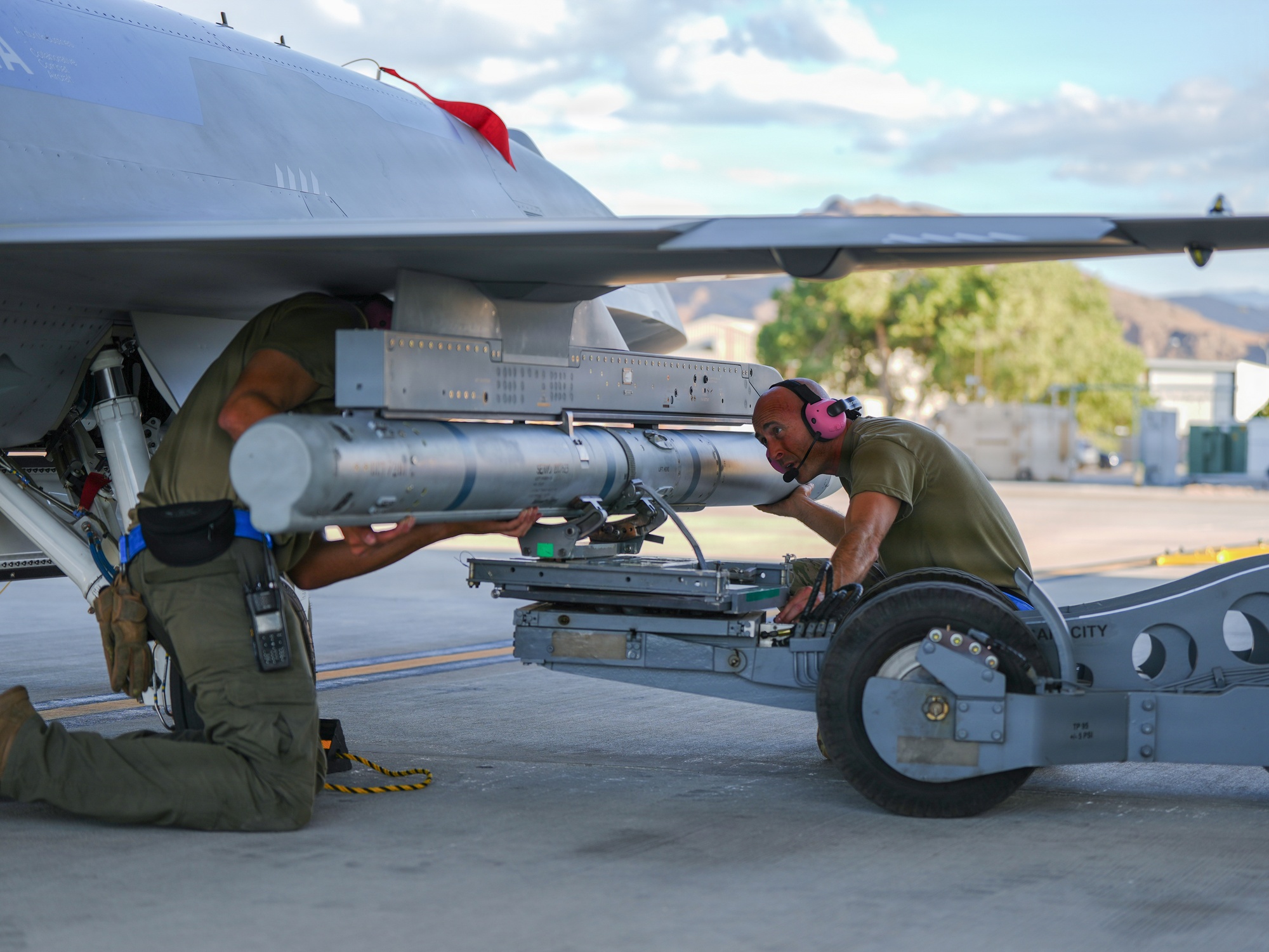 Airmen load an inert missile on a YFQ-44A Fury at Creech AFB