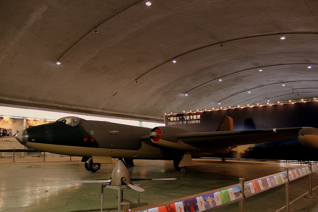 A camouflaged ex-Zimbabwe Air Force English Electric Canberra B.2 bomber preserved in an aviation museum