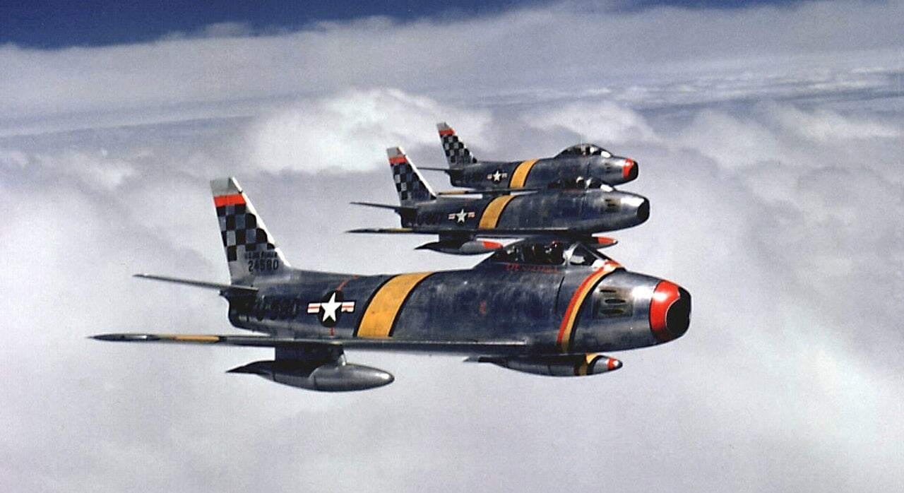 Three F-86F Sabres of the US Air Force 51st Fighter-Interceptor Wing with checkerboard tails flying over Korea in 1953