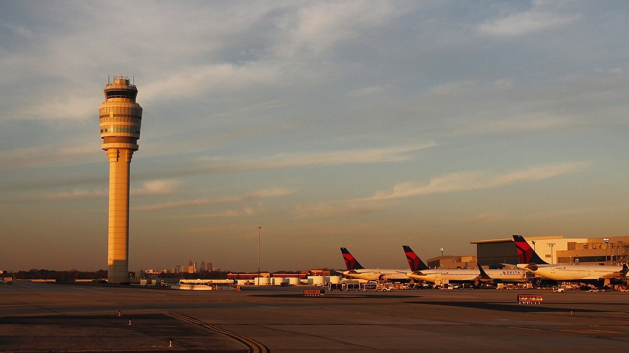 Atlanta Hartsfield-Jackson control tower at sunset The air traffic control tower at Atlanta Hartsfield-Jackson airport at sunset with Delta jets at the gates