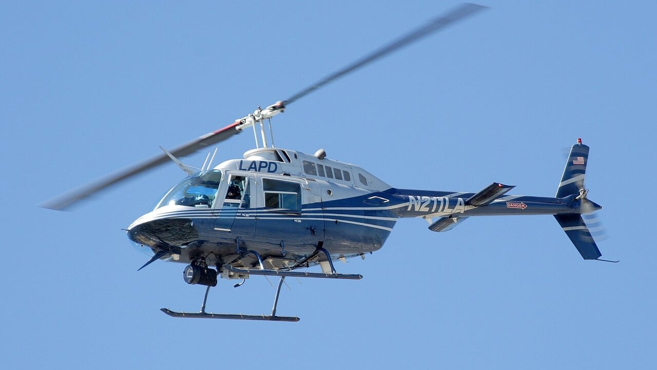 A Los Angeles Police Department Bell 206 JetRanger helicopter in flight against a blue sky