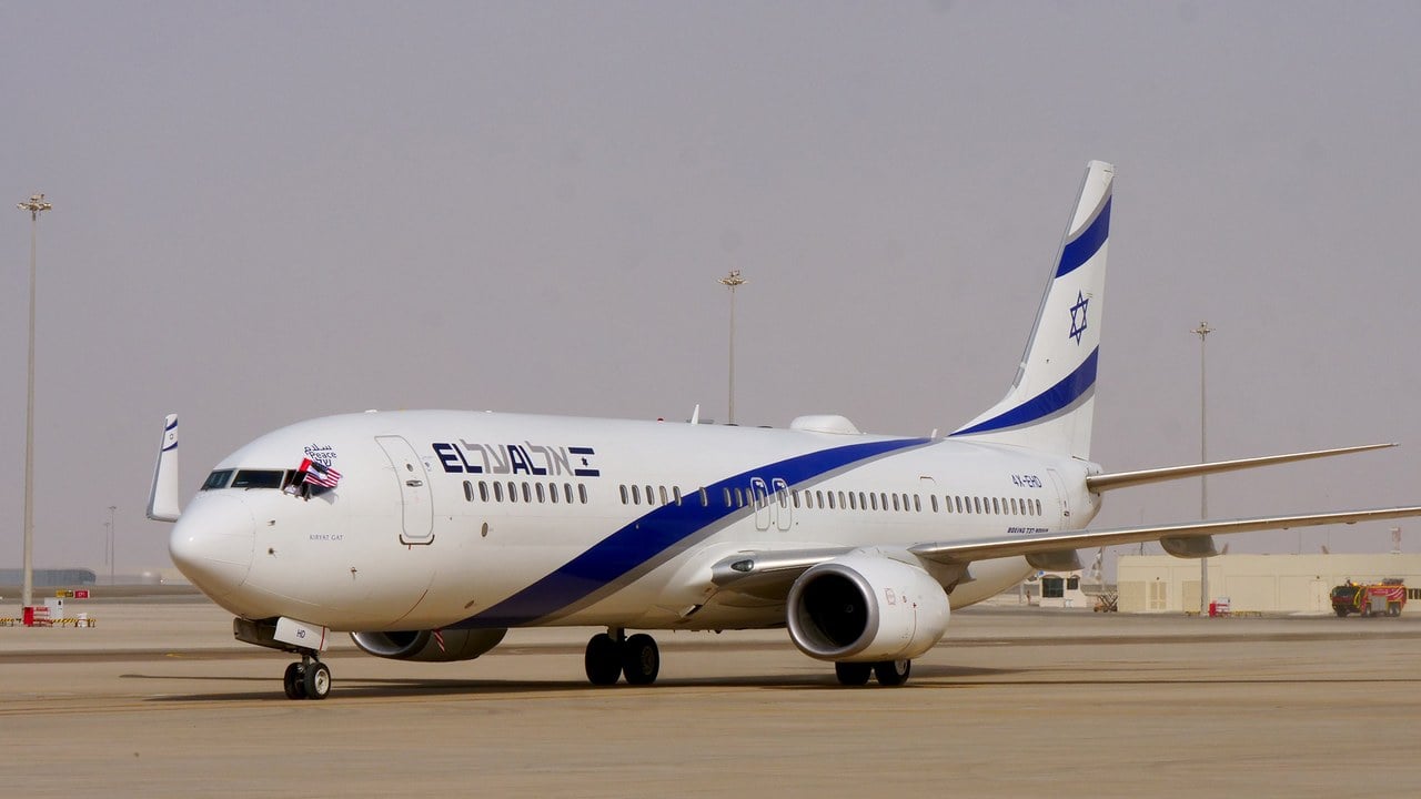 El Al Boeing 737-900ER 4X-EHD Kiryat Gat on the apron at Abu Dhabi International Airport, with the word peace in Arabic, English and Hebrew above the cockpit