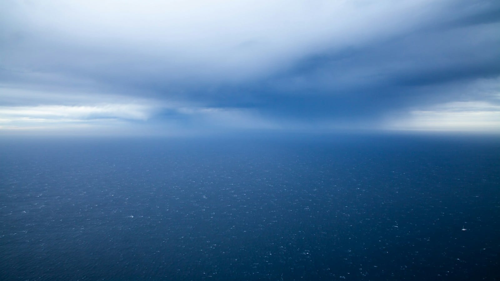 The open North Atlantic seen from cruising altitude Open ocean under a weather system seen from an airliner at altitude