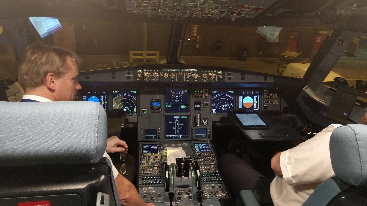 Airbus A320 cockpit with two pilots Two pilots seated in the cockpit of an SAS Airbus A320 at Stockholm Arlanda