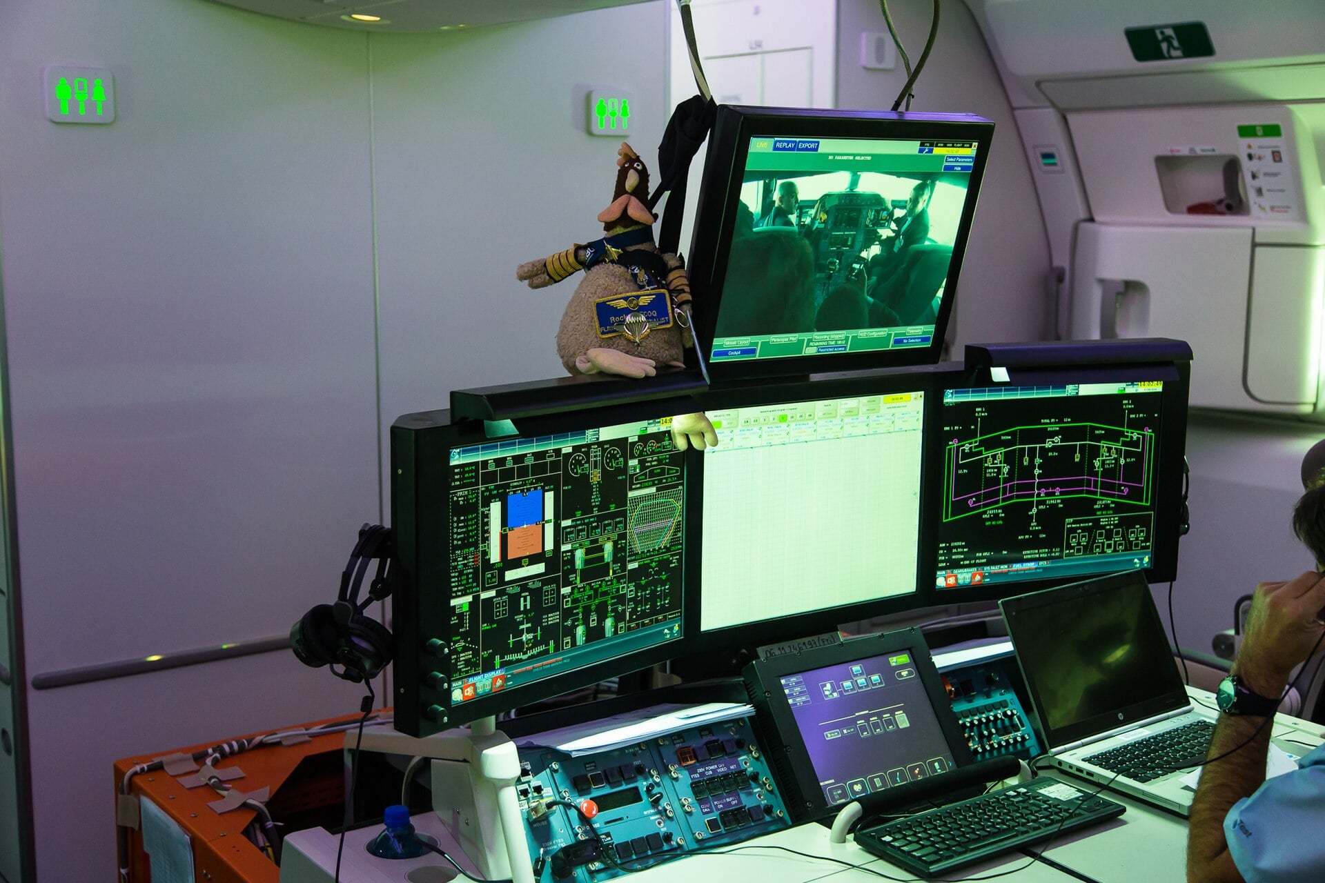 Flight test engineer station aboard an Airbus A350 XWB, with live parameter displays and a cockpit video feed