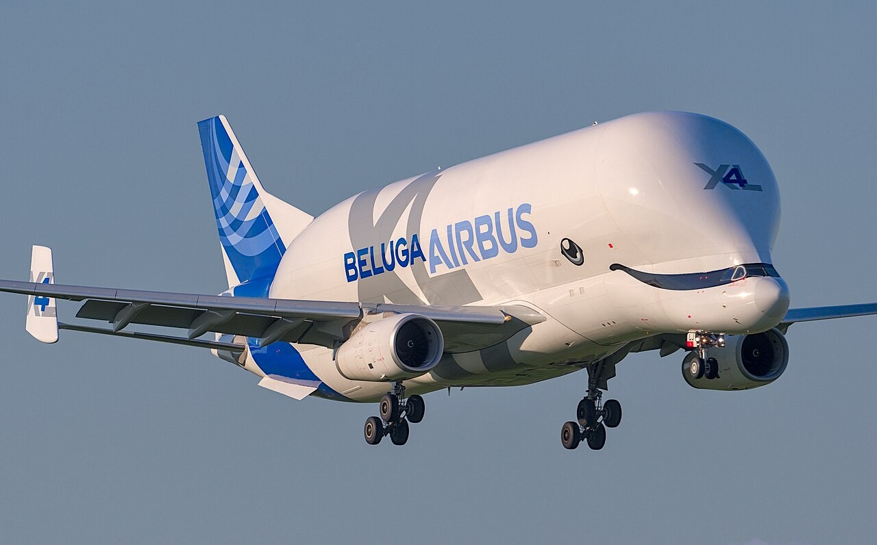 A BelugaXL, registration F-GXLJ, on approach to Toulouse-Blagnac with gear down, showing the painted eyes and smile on its nose