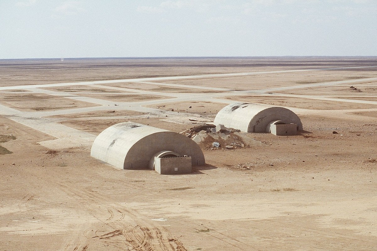 Two concrete hardened aircraft shelters with bomb damage at Al-Salman Air Base in Iraq after Operation Desert Storm