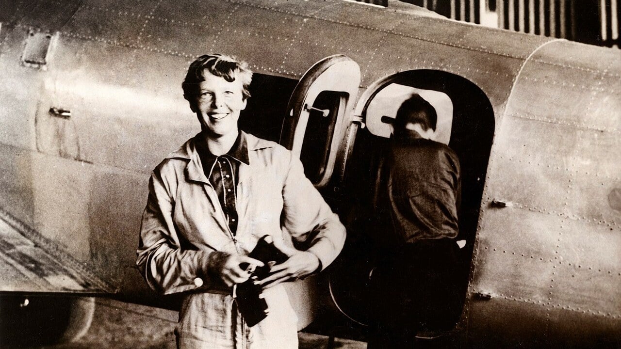 Amelia Earhart and her Lockheed Electra 10E, 1937 Amelia Earhart standing beside her Lockheed Electra 10E in 1937, with Fred Noonan at the cabin door