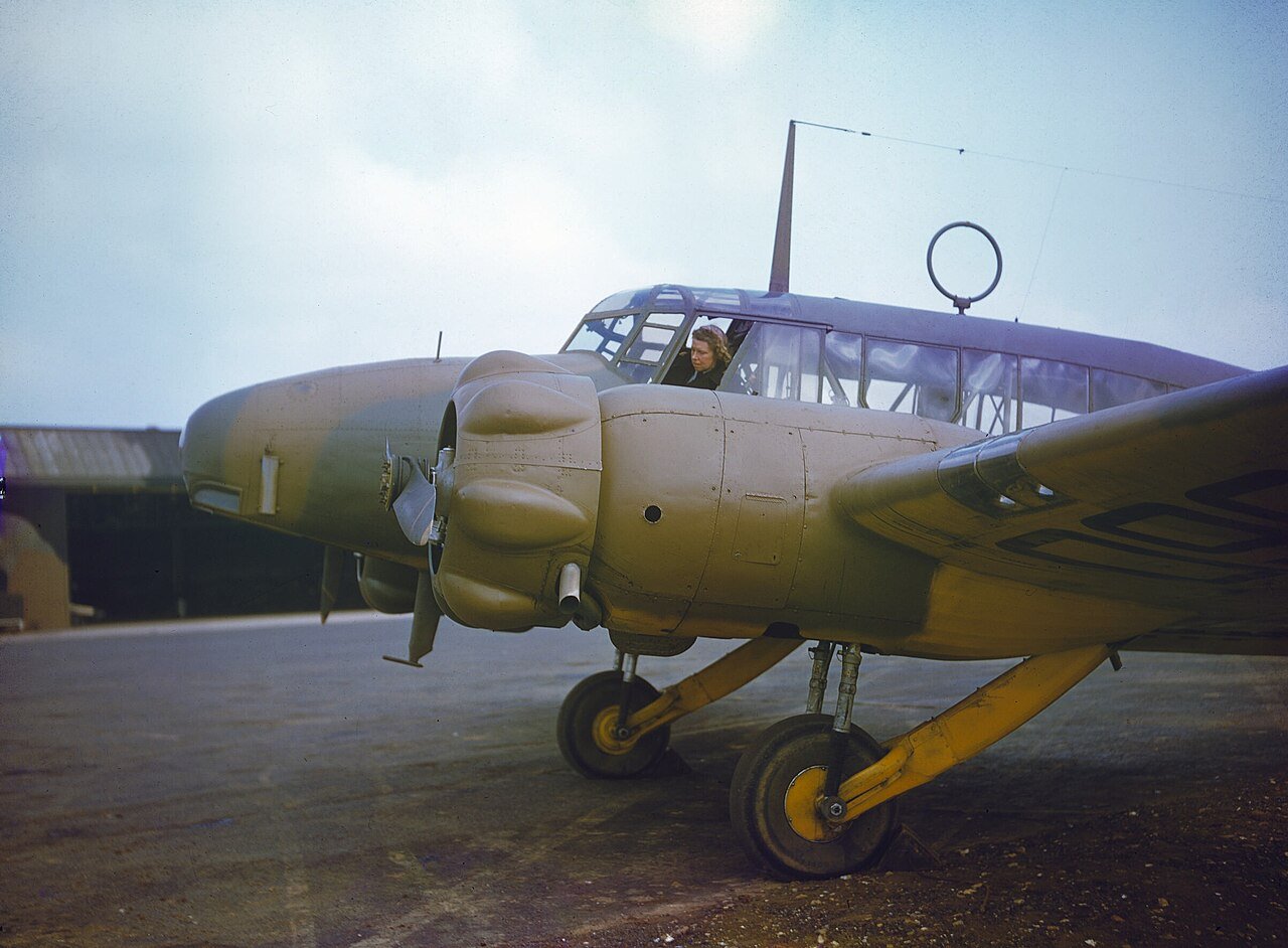 A woman pilot of the Air Transport Auxiliary in the cockpit of Avro Anson N5060 in 1942, in a wartime colour photograph