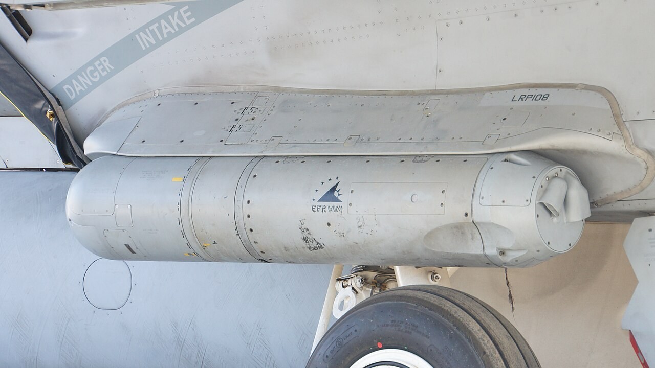 An AN/ASQ-228 ATFLIR targeting pod mounted on the fuselage of a US Navy F/A-18E Super Hornet