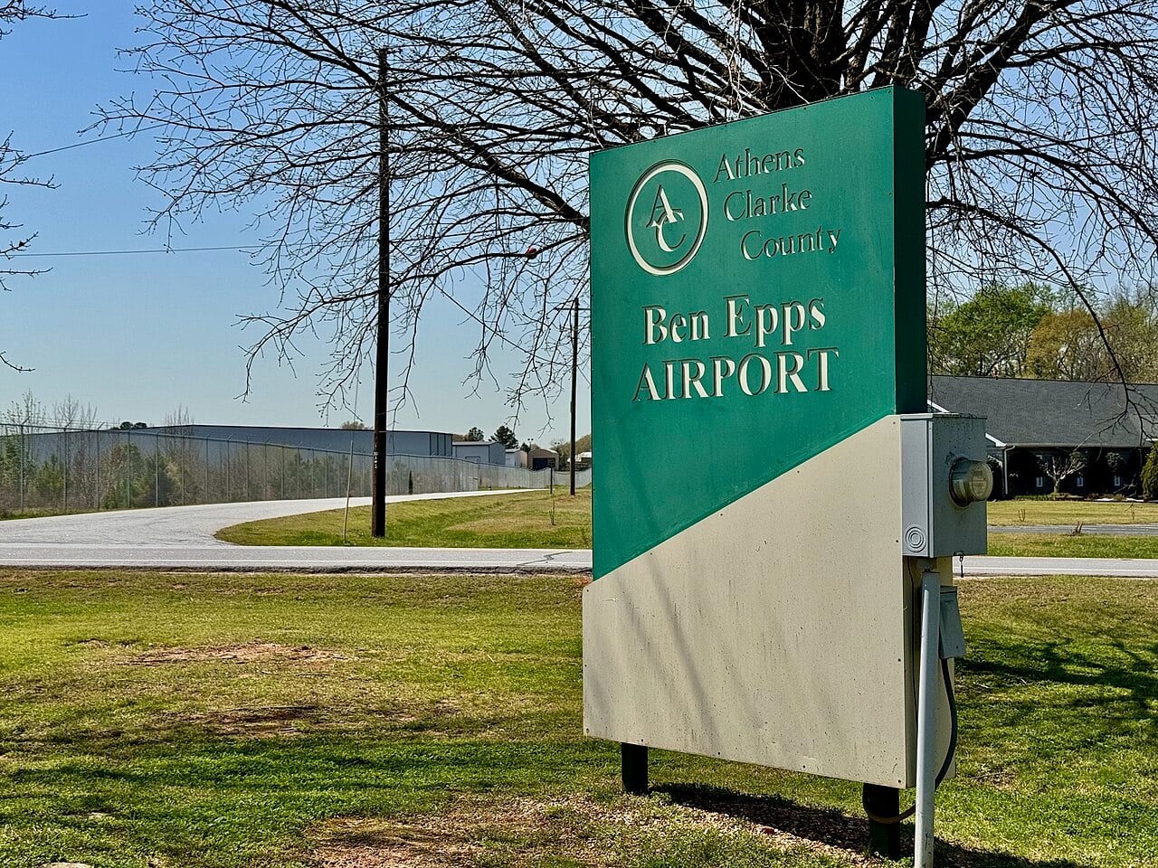 Green Athens-Clarke County Ben Epps Airport entrance sign beside the airport road