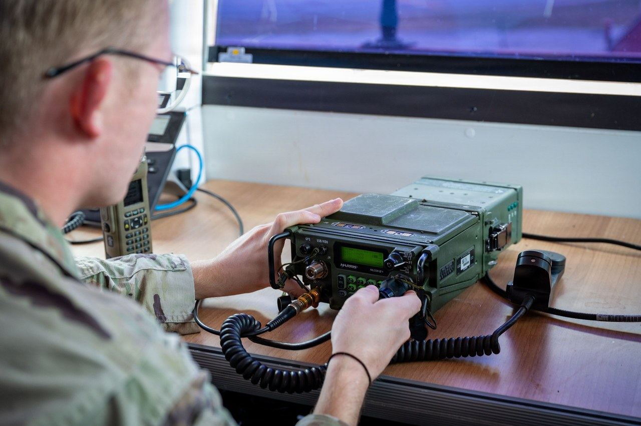 US Air Force air traffic controller programming a radio in the alternate control tower at Aviano Air Base