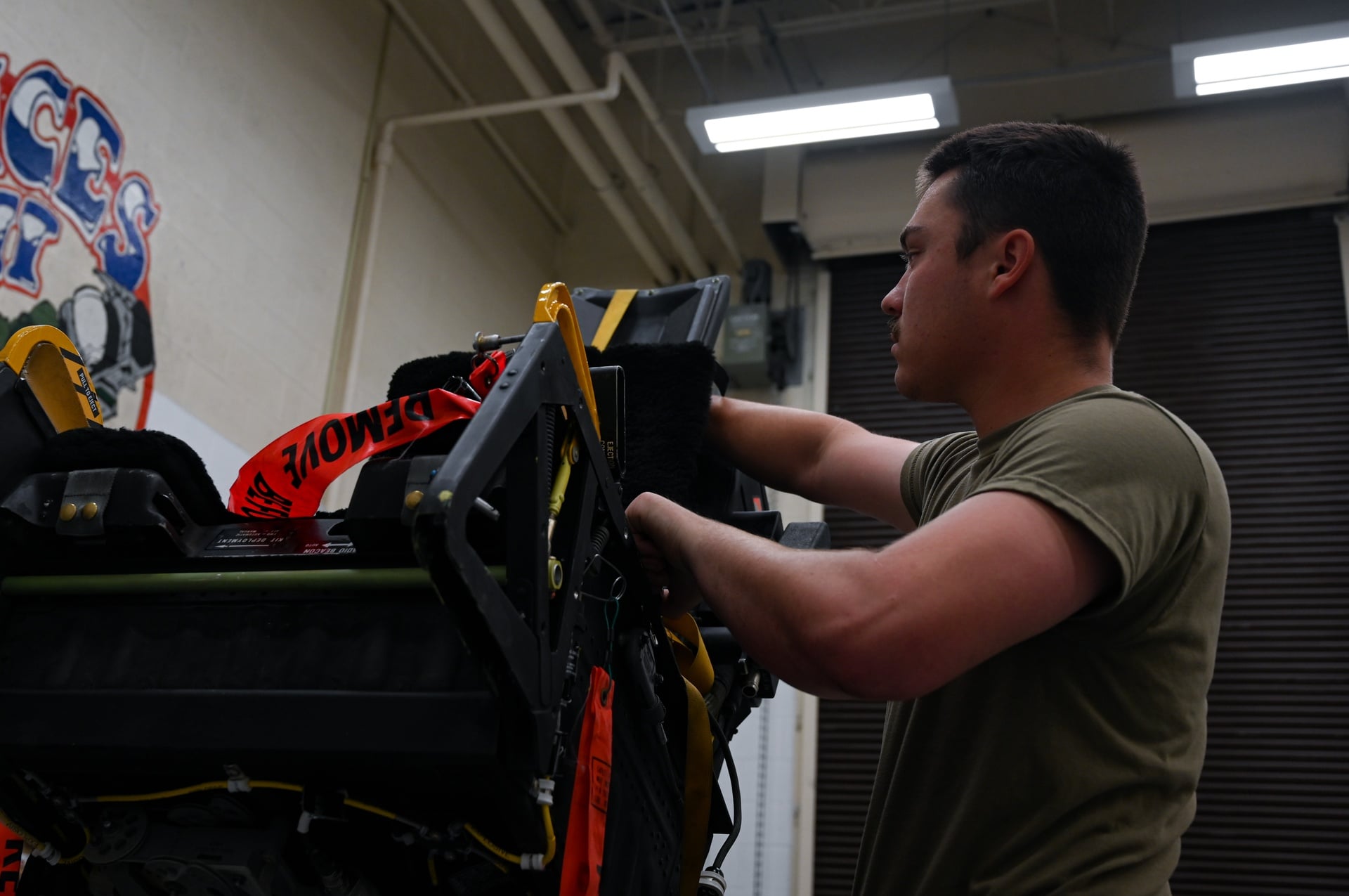 US Air Force egress technician setting up a B-2 Spirit ejection training seat at Whiteman Air Force Base