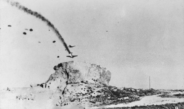 German paratroopers jumping from a Junkers Ju 52 over Heraklion, Crete, as a second Ju 52 trails smoke
