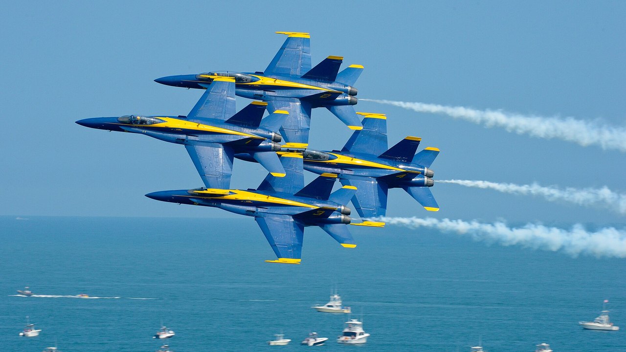 Blue Angels Diamond 360 at Ocean City, 2015 Four Blue Angels F/A-18 Hornets in tight diamond formation trailing smoke over the sea at Ocean City Air Show