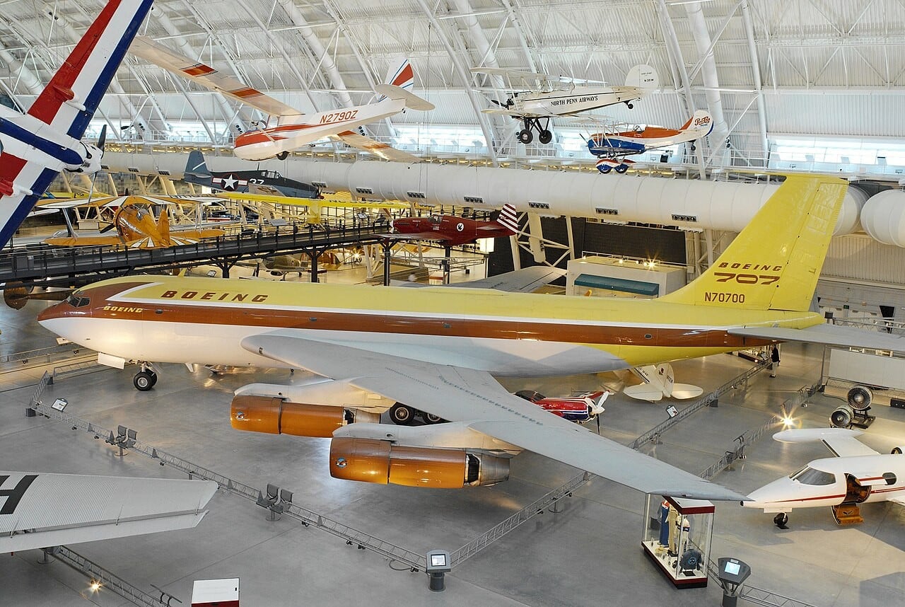 The yellow and brown Boeing 367-80 Dash 80, prototype of the Boeing 707, on display showing its swept wing and podded engines
