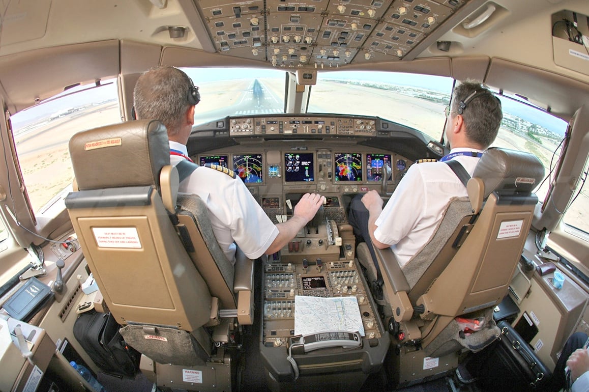 Boeing 777 flight deck seen from behind the pilots