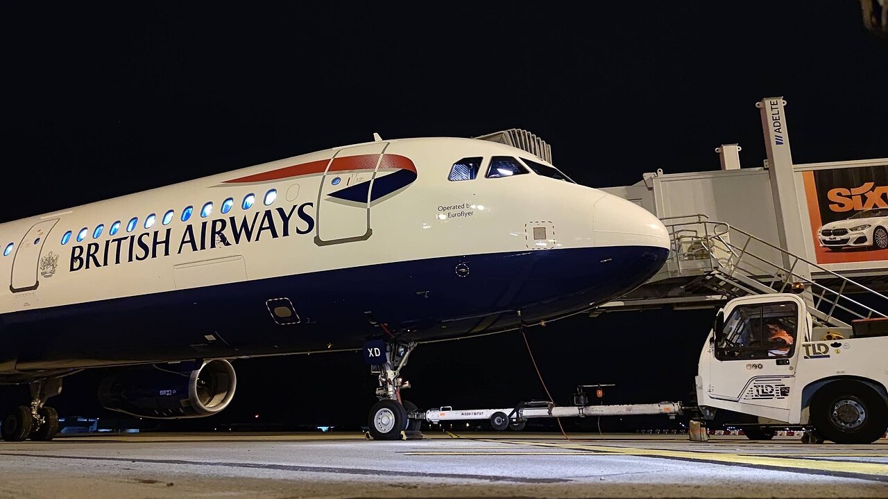 British Airways Airbus A321 G-EUXD, operated by BA Euroflyer, at the gate at night