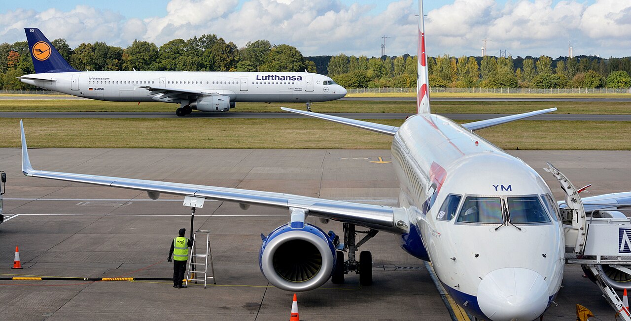 British Airways Embraer being refuelled at Edinburgh with a Lufthansa Airbus taxiing behind
